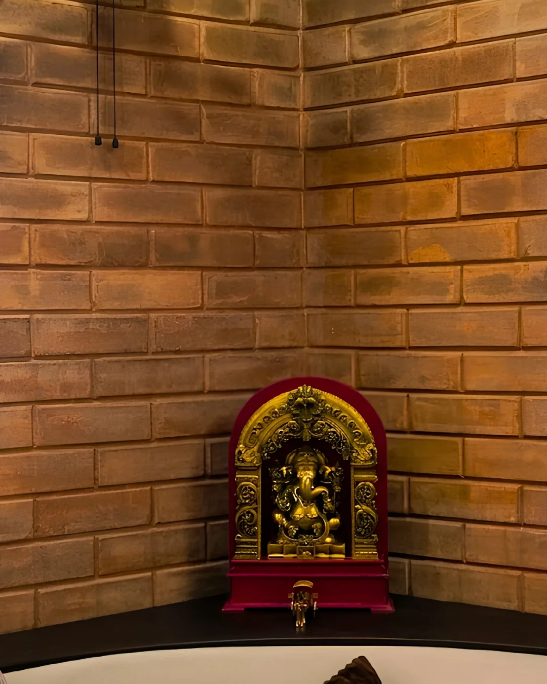 A shrine set into a curved wall of earth block